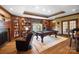 Game room with pool table, fireplace, and custom built-in bookshelves at 20428 Island Forest Dr, Cornelius, NC 28031