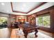 Game room with pool table, fireplace, and custom built-in bookshelves at 20428 Island Forest Dr, Cornelius, NC 28031