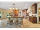 Spacious kitchen with island, counter seating, and view of the stainless steel appliances and wood cabinetry at 20428 Island Forest Dr, Cornelius, NC 28031