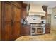 Gourmet kitchen with stainless steel appliances and dark wood cabinets is a home chef's dream at 20428 Island Forest Dr, Cornelius, NC 28031