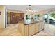 Bright kitchen features a large island, custom cabinetry, stone floors, and a view of the lake at 20428 Island Forest Dr, Cornelius, NC 28031