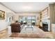 A light filled living room boasts large windows, a fireplace, and water views at 20428 Island Forest Dr, Cornelius, NC 28031