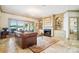 Cozy living room showcasing fireplace, built-in shelving, and access to outdoor patio with lake views at 20428 Island Forest Dr, Cornelius, NC 28031