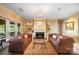 Spacious living room with stone floors, fireplace, built ins, and lake views at 20428 Island Forest Dr, Cornelius, NC 28031