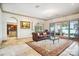Spacious living room with fireplace, beautiful lake views, and comfortable seating at 20428 Island Forest Dr, Cornelius, NC 28031