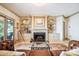 Elegant living room with fireplace, built-in shelving, and sliding doors to outdoor patio at 20428 Island Forest Dr, Cornelius, NC 28031