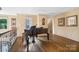 Sitting room with black piano at 20428 Island Forest Dr, Cornelius, NC 28031