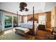 Spacious bedroom with four-poster bed, ceiling fan and outdoor access at 20428 Island Forest Dr, Cornelius, NC 28031
