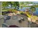Lake view from the custom patio with a fire pit, outdoor seating and lush landscaping at 20428 Island Forest Dr, Cornelius, NC 28031