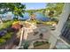 Stunning lake view from the custom patio with a fire pit and lush landscaping at 20428 Island Forest Dr, Cornelius, NC 28031