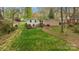 View of the backyard featuring a lush lawn, exterior of the house, and wooden deck at 2239 Wensley Dr, Charlotte, NC 28210