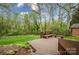 Tranquil backyard featuring a wood deck surrounded by lush greenery at 2239 Wensley Dr, Charlotte, NC 28210