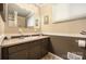 Bathroom with a single sink vanity, with neutral countertop and mocha colored cabinets at 2239 Wensley Dr, Charlotte, NC 28210