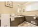 Cozy bathroom featuring a sink with taupe cabinets and a decorative towel rack at 2239 Wensley Dr, Charlotte, NC 28210