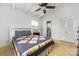 Inviting bedroom with hardwood floors, ceiling fan, and an ensuite half bathroom at 2239 Wensley Dr, Charlotte, NC 28210