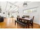 Dining room with hardwood floors, a vaulted ceiling, large windows, and views to the living room at 2239 Wensley Dr, Charlotte, NC 28210