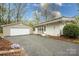 Charming single-story home featuring a detached garage and well-manicured lawn at 2239 Wensley Dr, Charlotte, NC 28210