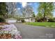 Attractive home features a well-maintained driveway with lovely landscaping and a detached garage at 2239 Wensley Dr, Charlotte, NC 28210