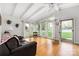 Bright living room with large windows, hardwood floors, and a comfortable leather sofa at 2239 Wensley Dr, Charlotte, NC 28210