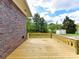 Wooden back deck overlooks lawn and storage shed under a blue sky at 225 Enwood Dr, Charlotte, NC 28214