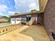 Wooden back deck looks towards back of brick home with garage at 225 Enwood Dr, Charlotte, NC 28214