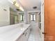 Bathroom featuring white tile, vanity and shower at 225 Enwood Dr, Charlotte, NC 28214