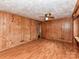 Bedroom with wooden paneling, ceiling fan, and wood-look laminate flooring at 225 Enwood Dr, Charlotte, NC 28214