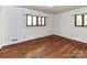 Bright bedroom with hardwood floors and natural light from two windows at 225 Enwood Dr, Charlotte, NC 28214