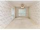 Bedroom with floral wallpaper, carpeted floor, plantation shutters, and ceiling fan with light at 225 Enwood Dr, Charlotte, NC 28214