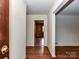 Inviting entryway featuring hardwood floors and view of a room with custom shelving at 225 Enwood Dr, Charlotte, NC 28214