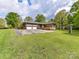 Charming brick home with a two-car garage, spacious driveway, and a beautifully maintained lawn at 225 Enwood Dr, Charlotte, NC 28214