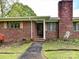 Close-up of a brick home's front entrance and well-maintained landscaping at 225 Enwood Dr, Charlotte, NC 28214