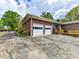 A two car garage sits beside the brick home with fresh landscaping at 225 Enwood Dr, Charlotte, NC 28214