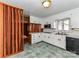Bright kitchen features white cabinets, updated appliances, and tile flooring at 225 Enwood Dr, Charlotte, NC 28214