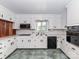 Functional kitchen boasts white cabinetry, tile floor, and modern appliances at 225 Enwood Dr, Charlotte, NC 28214