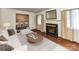 Bright living room features hardwood floors, elegant fireplace, and an open dining space at 225 Enwood Dr, Charlotte, NC 28214
