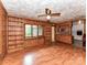 Cozy living room features wood-paneled walls, hardwood floors, and built-in bookshelves at 225 Enwood Dr, Charlotte, NC 28214
