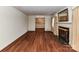 Spacious living room features hardwood floors, elegant fireplace, and a serene mural on the dining space wall at 225 Enwood Dr, Charlotte, NC 28214