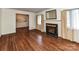 Spacious living room features hardwood floors, elegant fireplace, and a serene mural on the dining space wall at 225 Enwood Dr, Charlotte, NC 28214
