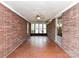 Spacious sunroom with brick walls, tile floors, and a ceiling fan at 225 Enwood Dr, Charlotte, NC 28214