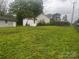 Wide-angle view of a lush green backyard featuring a storage shed and partial fencing at 229 N Jones Ave, Rock Hill, SC 29730