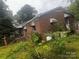 Angled view of brick house, showcasing lush green foliage, creating a private, natural screen at 229 N Jones Ave, Rock Hill, SC 29730