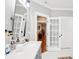 Bathroom featuring a large vanity with a white countertop and mirrors, along with a connecting doorway at 2315 Dundeen St, Charlotte, NC 28216