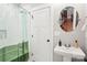 Bright bathroom with a pedestal sink, tiled walls, and stylish fixtures at 2315 Dundeen St, Charlotte, NC 28216