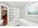 Bathroom featuring a soaking tub, and a doorway to the connecting room at 2315 Dundeen St, Charlotte, NC 28216