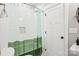 Bathroom features a white tiled wall and a unique green-tinted shower curtain at 2315 Dundeen St, Charlotte, NC 28216