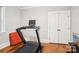 Bedroom with hardwood floors and a treadmill next to closet doors at 2315 Dundeen St, Charlotte, NC 28216
