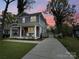 Charming two-story home featuring a welcoming front porch with white columns and chairs at 2315 Dundeen St, Charlotte, NC 28216