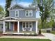 Inviting two-story home showcasing a classic design, front porch, and manicured lawn at 2315 Dundeen St, Charlotte, NC 28216