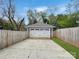 Detached two car garage enclosed by a fence and accessible via a long driveway at 2315 Dundeen St, Charlotte, NC 28216